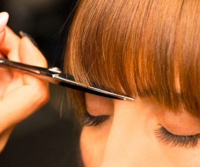 The woman struggles with how to fix her bangs.